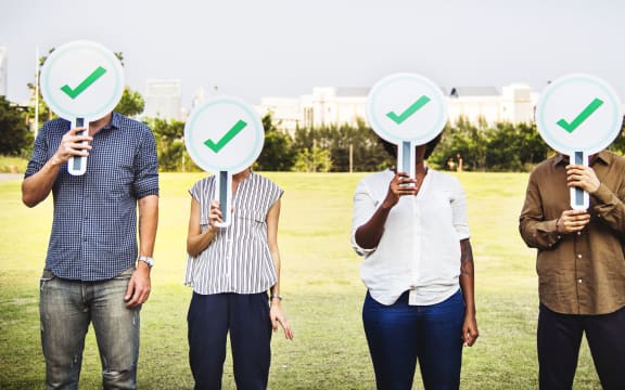 Diverse friends holding checkmark icons