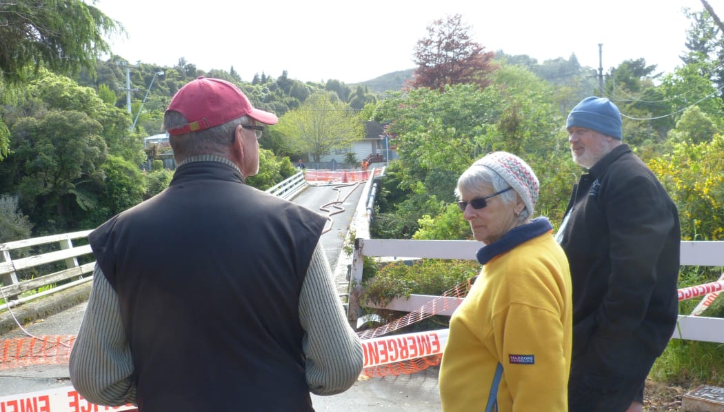 Residents on Bridge Road in Birchville standing near their collapsed bridge over the Akatarawa River.
