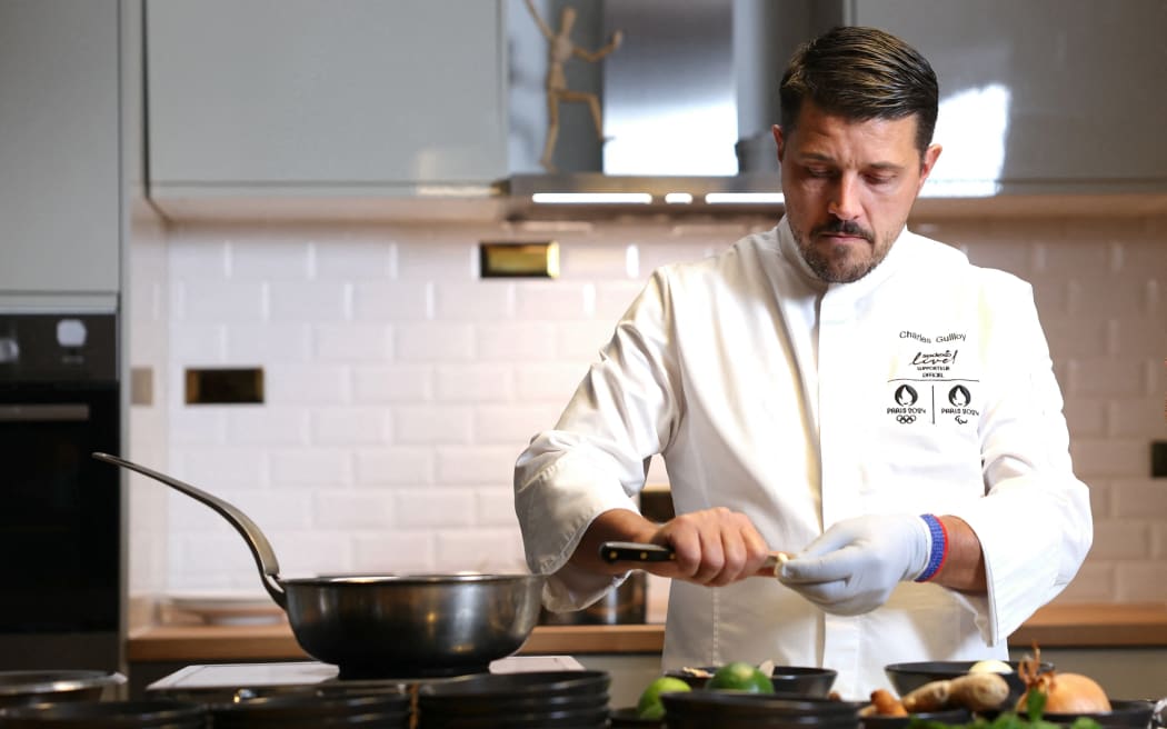 Executive chef for the Olympic Village of the Paris 2024 Olympic and Paralympic Games, Charles Guilloy from Sodexo Live!, cooks during a photo session in Rungis, near Paris, on December 4, 2023.