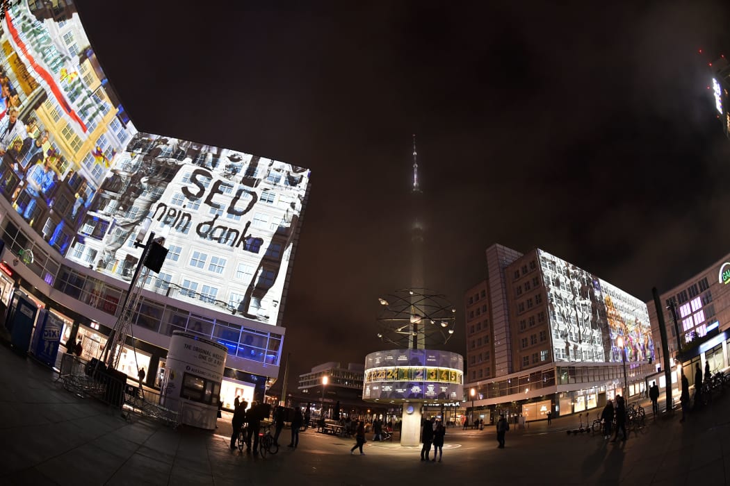 Historic pictures and others are projected on the buildings at Alexanderplatz during the rehearsal for the 30th anniversary of the November 9,1989 fall of the Berlin Wall, in Berlin on November 3, 2019.