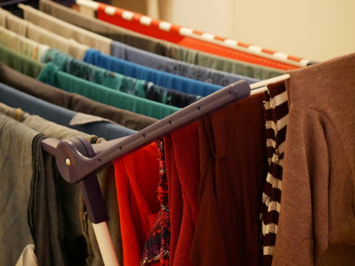 Clothes hanging on an airer indoors.