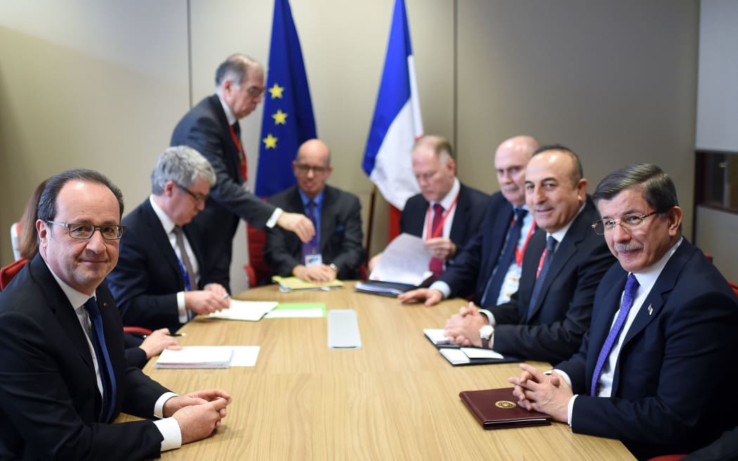 French President Francois Hollande with with Turkish Prime Minister Ahmet Davutoglu and Foreign Minister Mevlut Cavusoglu in Brussels
