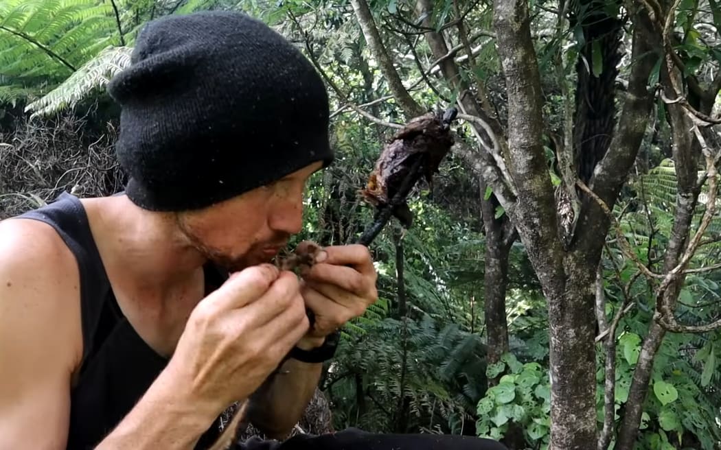 Shay Williamson eating a cooked hedehog. Screenshot: YouTube / Keeping it Wild
