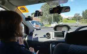 Susan takes Islam for her driving lesson before she sits her restricted test.