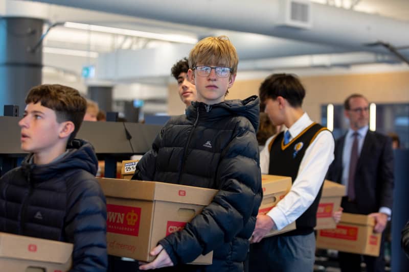 Rongotai College is back to help Wellington Library move books back in