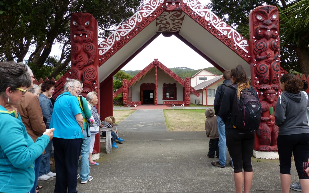 Tour group stands at the entrance of Takapuwahia Marae, ready to be welcomed.