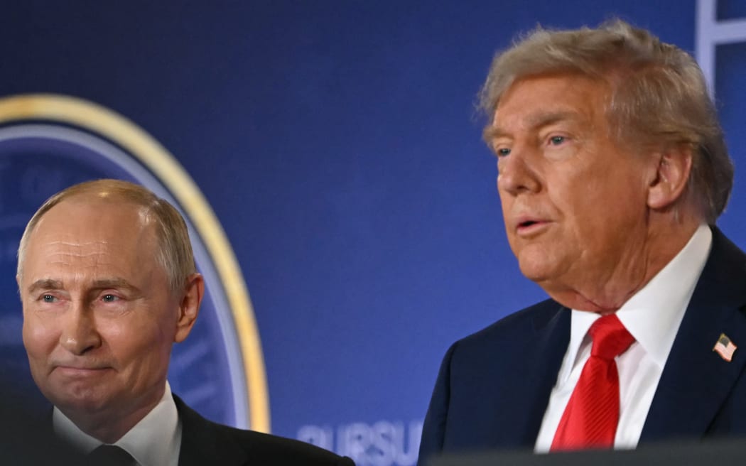US President Donald Trump (R) and Russian President Vladimir Putin stand together after delivering a joint press conference after participating in a US-Russia summit on Ukraine at Joint Base Elmendorf-Richardson in Anchorage, Alaska, on August 15, 2025. (Photo by ANDREW CABALLERO-REYNOLDS / AFP)