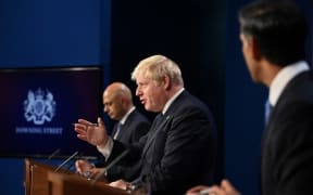 Britain's Prime Minister Boris Johnson (C), Britain's Health Secretary Sajid Javid (L) and Britain's Chancellor of the Exchequer Rishi Sunak attend a press conference inside the Downing Street Briefing Room in central London on September 7, 2021.