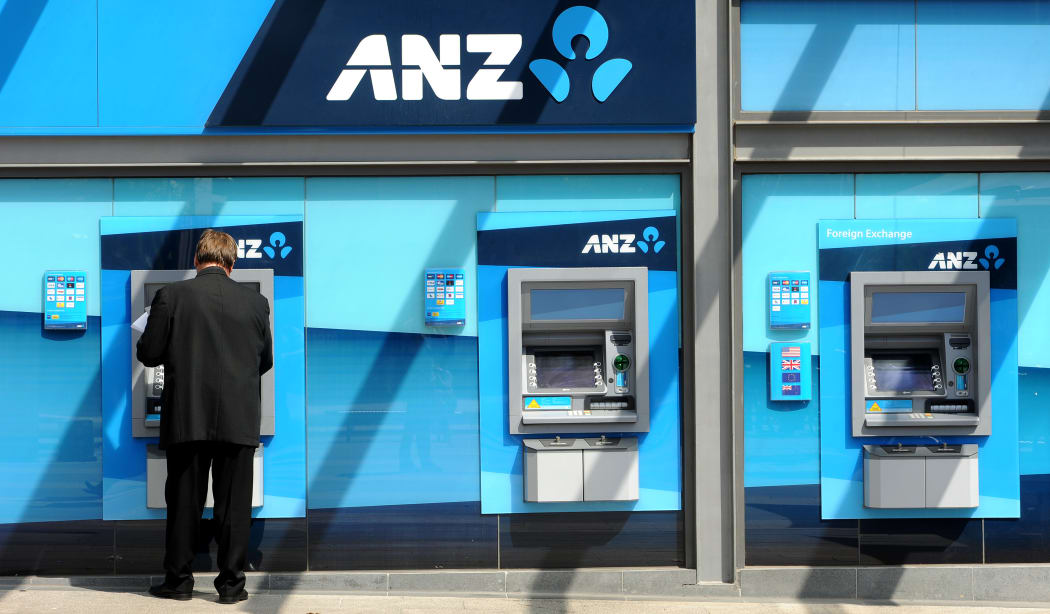 A man withdraws money from an ATM at the global headquarters of the Australia and New Zealand (ANZ) Bank in Melbourne on February, 2012.