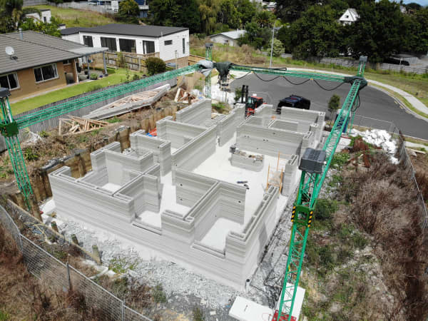 An overhead view of  a 3D-printed concrete house under construction.