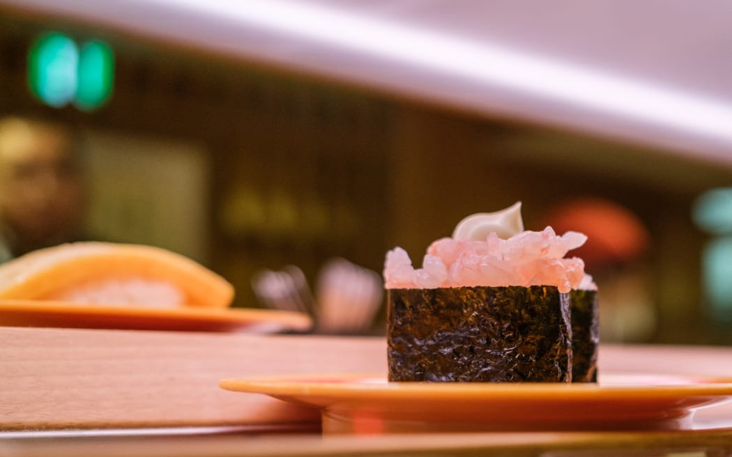 Plates of sushi on a conveyor belt at a sushi chain restaurant in Tokyo on 3 February, 2023.