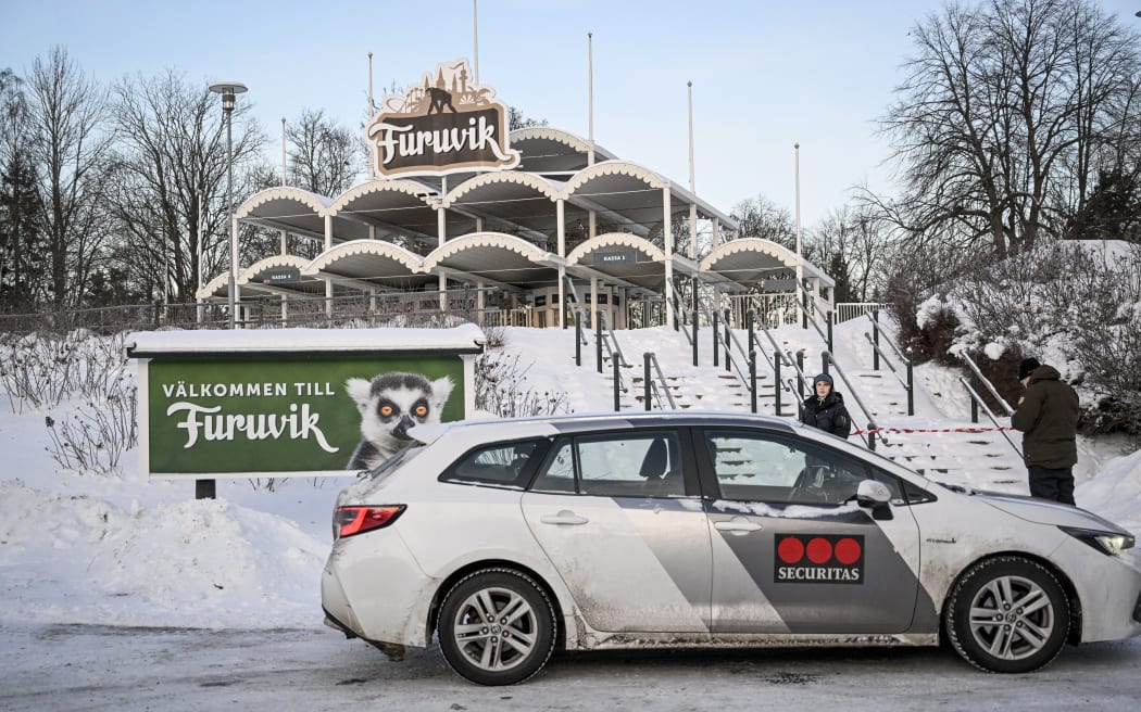 A photo taken on December 15, 2022 shows a vehicle of a security company near the main entrance of the Furuvik Zoo, around 10 km east of Gavle, Sweden. - A Swedish zoo was forced to put down three of its chimpanzees after they escaped from their enclosure on December 14, with the situation still out of control on December 15, according to the animal park. (Photo by Fredrik SANDBERG / TT News Agency / AFP) / Sweden OUT