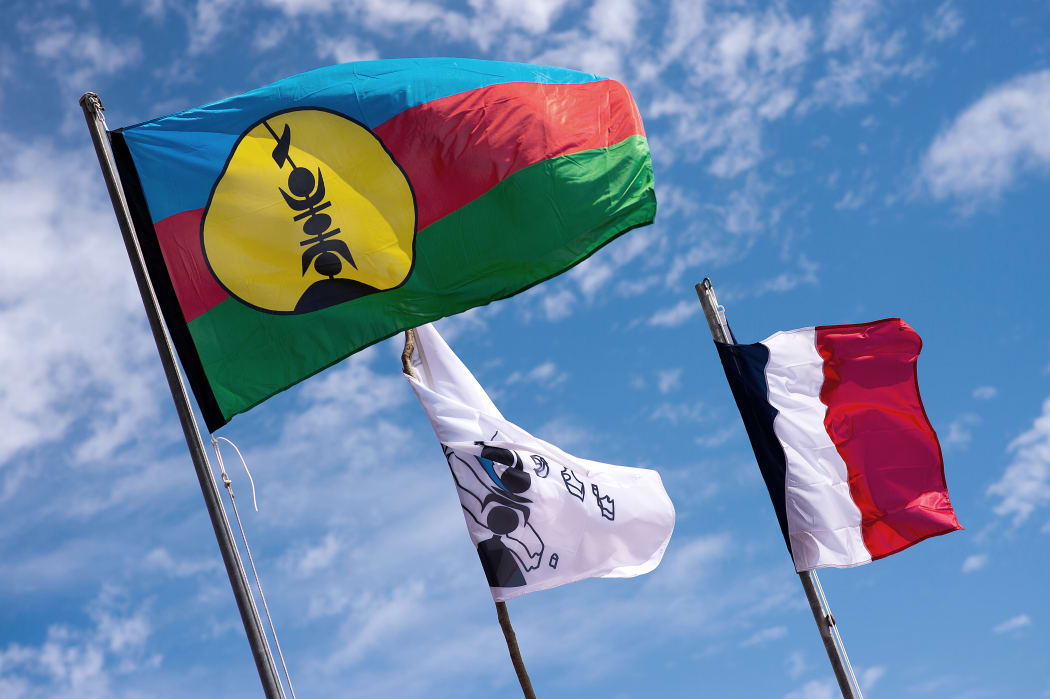 Kanak and French flags on Ouvea island.