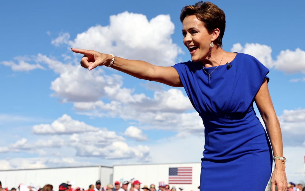 MESA, ARIZONA - OCTOBER 09: Arizona Republican nominee for governor Kari Lake points to the crowd at a 'Save America!' campaign rally with former U.S. President Donald Trump at Legacy Sports USA on October 09, 2022 in Mesa, Arizona. Former U.S. President Donald Trump is holding a campaign style rally for Arizona GOP candidates ahead of the state's midterm election on November 8th.   Mario Tama/Getty Images/AFP (Photo by MARIO TAMA / GETTY IMAGES NORTH AMERICA / Getty Images via AFP)