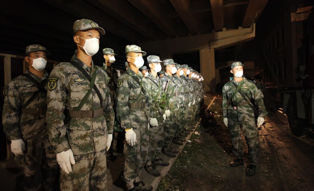 TIANJIN, Aug. 14, 2015 () -- Soldiers of the Tianjin Garrison wait to enter the core area of explosion site in Tianjin, north China, Aug. 14, 2015. An explosion, which occurred Wednesday night at a warehouse in Binhai, has left 50 people dead and 701 others injured. (/Wang Haobo) (lfj)