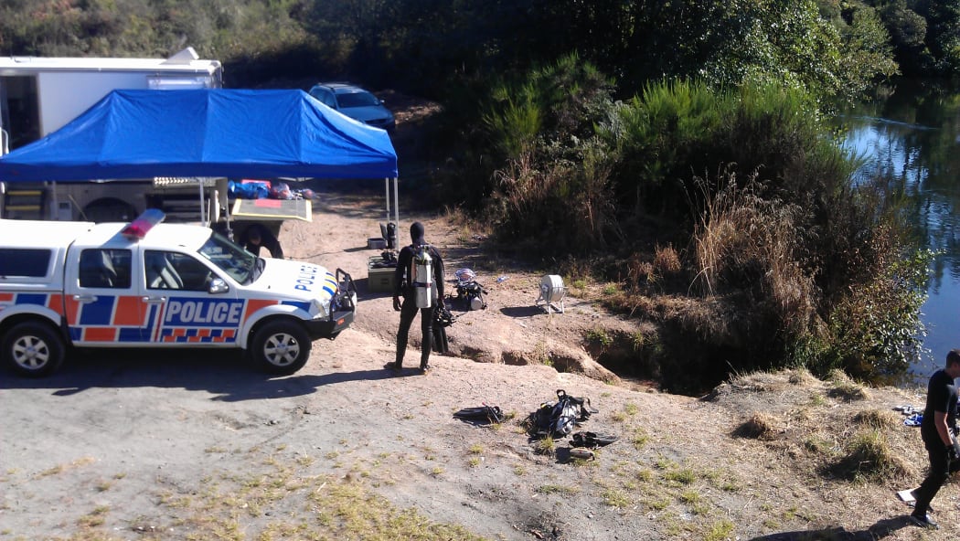 The police dive squad search the area where George Taiaroa was shot.