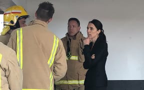 Prime Minister Jacinda Ardern talks to firefighters battling SkyCity blaze.