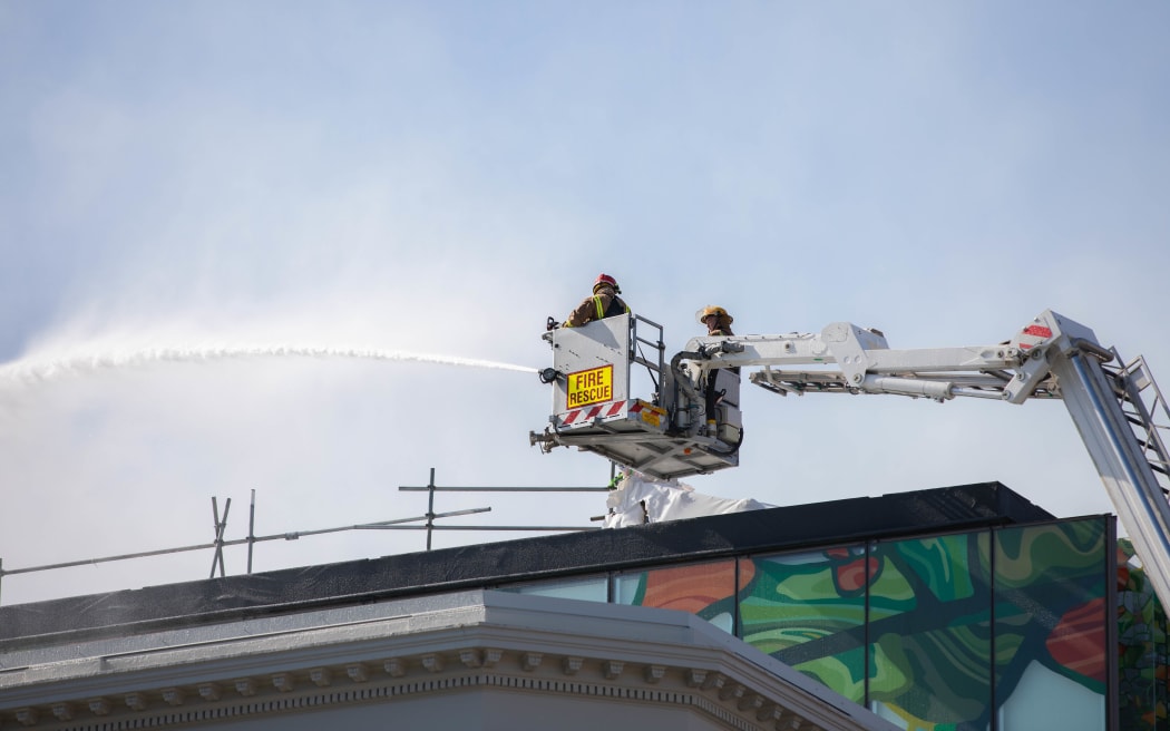 Firefighters douse the blaze on Tuesday.