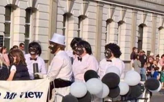 A Lions Club Christmas parade float featuring adults and children in black face, Hawera, 2018.