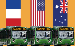 Buses with flags behind them.