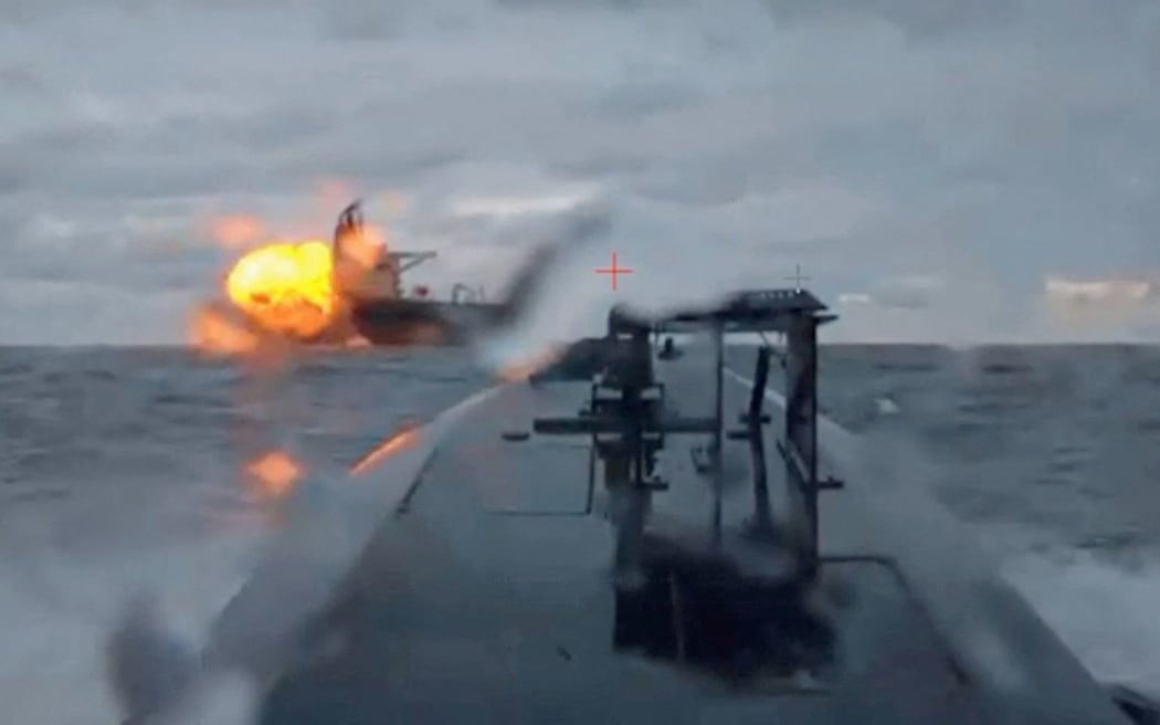 A Ukrainian sea drone shows the Dashan, a sanctioned oil tanker, being struck by another sea drone in the Black Sea on Tuesday, December 9, in a still from a video shared by Ukraine's Security Service.