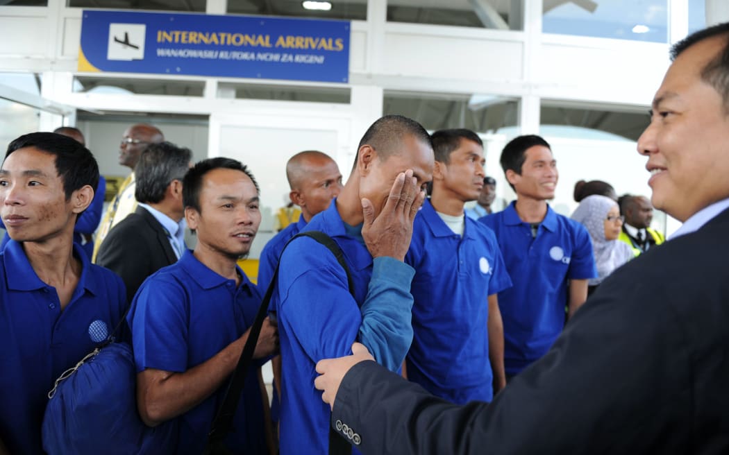 One of the hostages who had been held by Somali pirates for nearly five years reacts after arriving safely in Nairobi, Kenya.