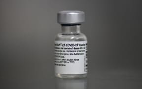 View of a vial of the Pfizer-BioNTech vaccine against COVID-19 at the Versalles Clinic, in Cali, Colombia, on February 19, 2021. (Photo by Luis ROBAYO / AFP)