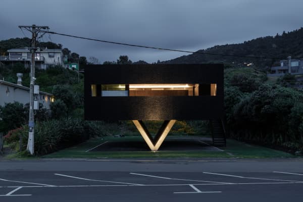 The Bunker House in Piha with a view of the carpark infront.