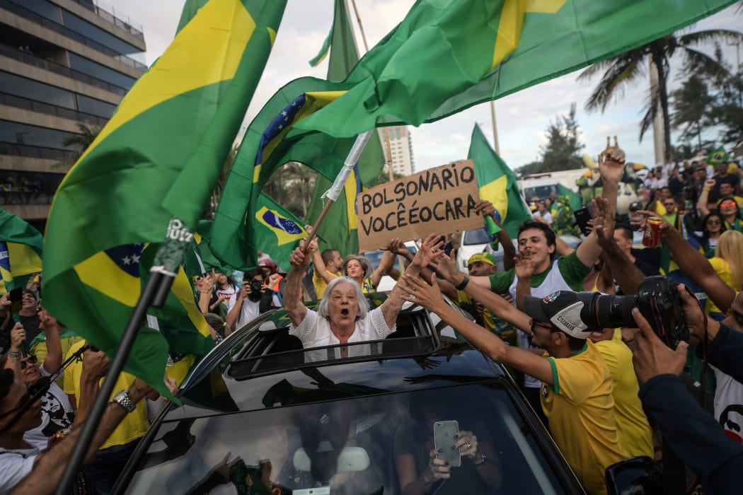 Supporters of far-right lawmaker and presidential candidate for the Social Liberal Party (PSL), Jair Bolsonaro, take part in a pro-Bolsonaro demonstration in Rio de Janeiro, Brazil, during the second round of the presidential elections.