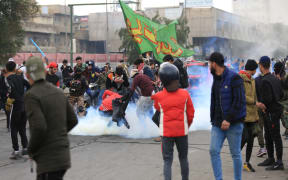 Iraqi security forces intervene in anti-government demonstrators at Tahrir Square in the centre of the Iraqi capital Baghdad on January 25, 2020.