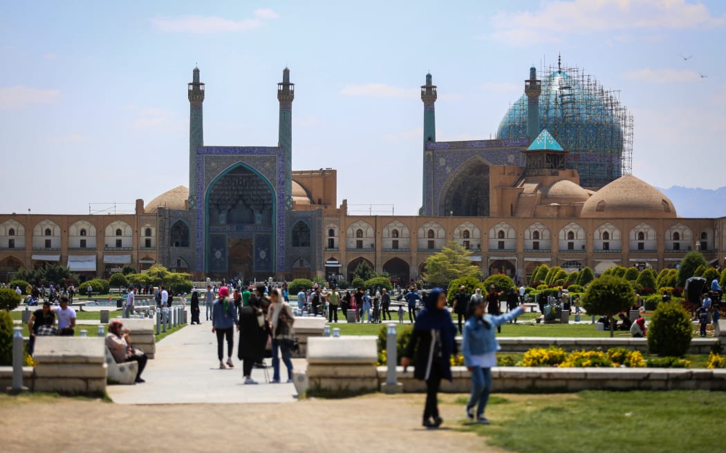 People visit the Naqsh-e Jahan Square in front of the Shah Mosque in Iran's central city of Isfahan on April 19, 2024. World leaders appealed for calm on April 19 after reported Israeli retaliation against Iran added to months of tense spillover from the war in Gaza, with Iranian state media reporting explosions in the central province of Isfahan. (Photo by Rasoul SHOJAEI / IRNA / AFP)