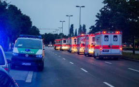 Police cars and ambulances are seen near the shopping mall in Munich following the shootings.