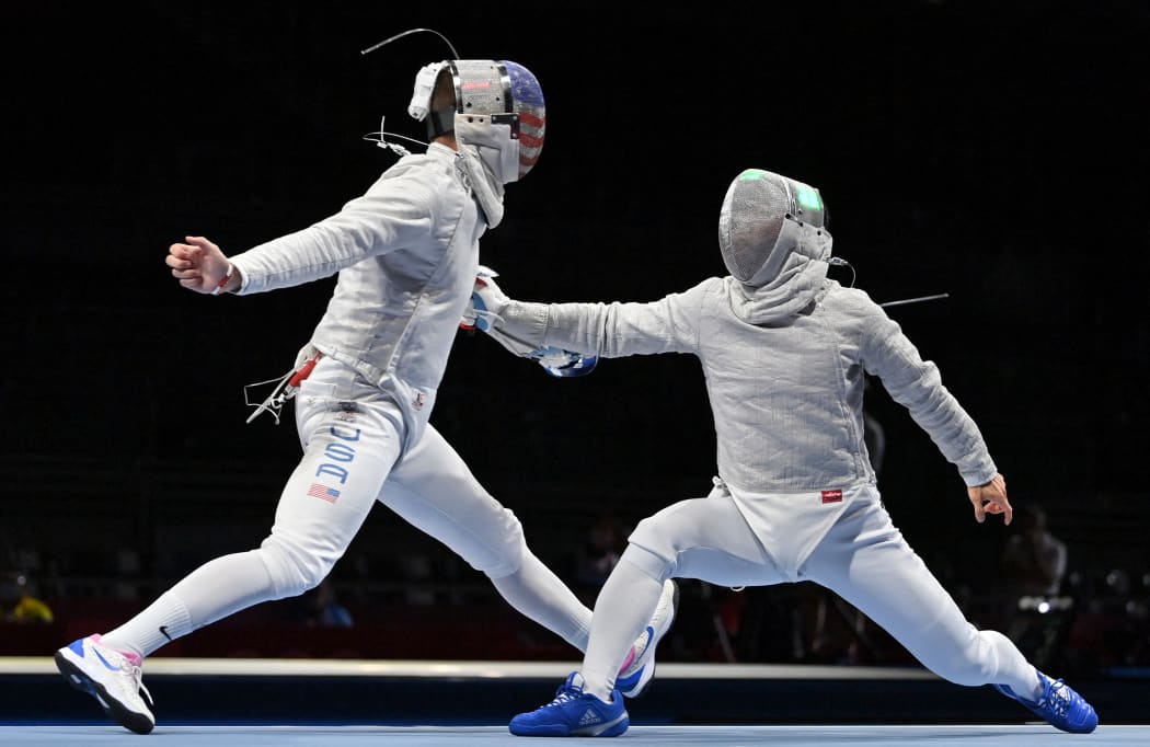 USA's Andrew Mackiewicz (L) competes against Japan's Tomohiro Shimamura in the men's sabre individual qualifying bout during the Tokyo 2020 Olympic Games