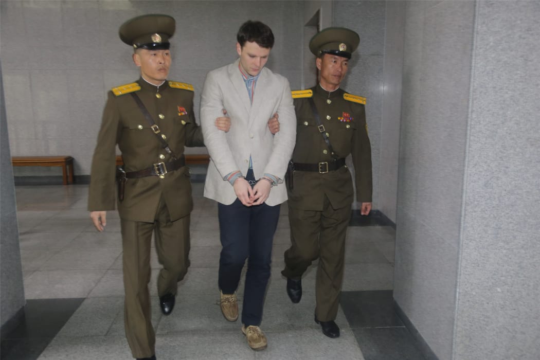 American student Otto Frederick Warmbier (centre) arrives at a court for his trial in Pyongyang.