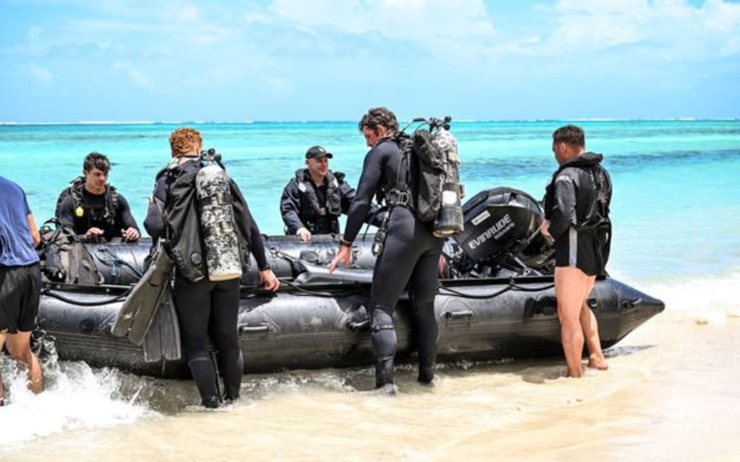 RNZN Divers prepare to set out and recover items from the HMNZS Manawanui off the Southern Coast of Upulo.
