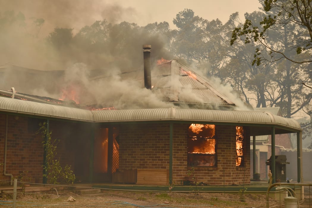 A property burns in bushfires in Balmoral, 150km southwest of Sydney, 19 December 2019.