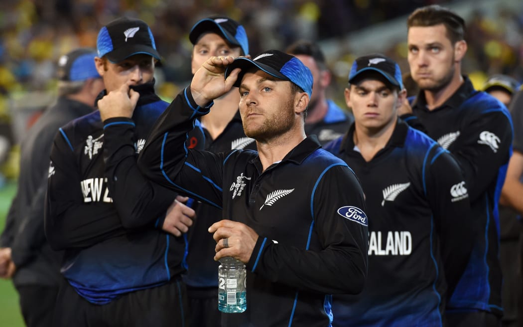 Brendon McCullum stands with his team after their Cricket World Cup final defeat.