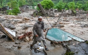A resident evacuates the area following a rise in floodwaters in the Buner district of Pakistan's Khyber Pakhtunkhwa province.