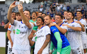 Auckland pose for a phone photo as they celebrate victory with a late goal by Neyder Moreno.
