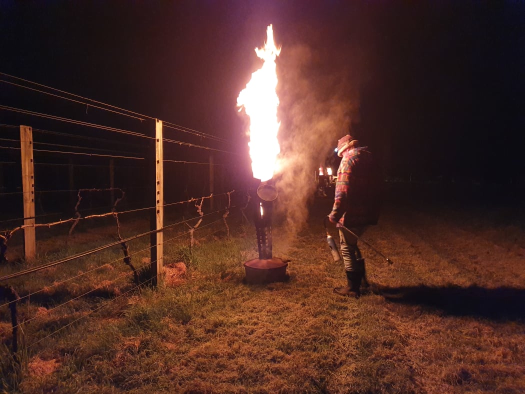 John Douglas lights his frost pots to protect the vines at his Te Hera Vineyard