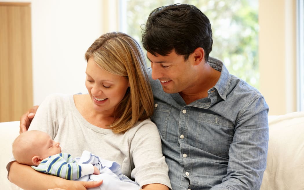 Couple at home with new baby