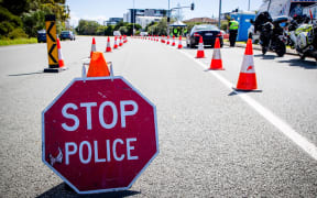 A vehicle stops at a checkpoint on the Pacific Highway on the Queensland - New South Wales border in Brisbane on April 15, 2020. -