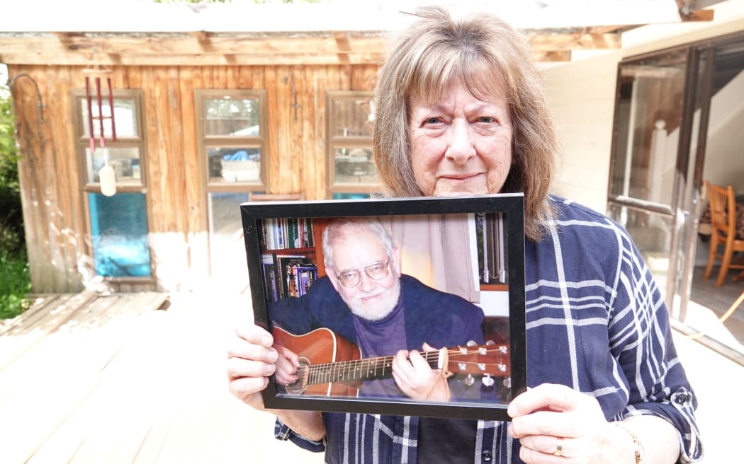 Christine Toms, with a picture of husband Arthur, says she's in limbo while she waits for answers about his death.