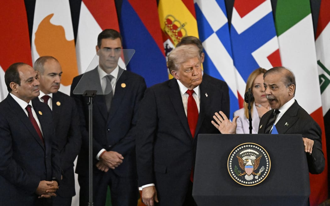 US President Donald Trump (C) listens to Pakistan's Prime Minister Shehbaz Sharif (R) as he delivers a statement during a summit on Gaza in Sharm el-Sheikh on October 13, 2025. Trump landed in Egypt on October 13 for a summit on Gaza, following a lightning visit to Israel after a ceasefire he brokered entered into force. (Photo by Khaled DESOUKI / AFP)