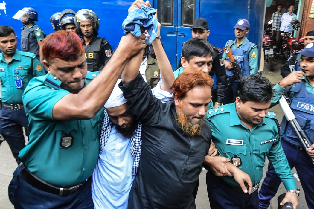 Police escort Islamist extremists who plotted the Holey Artisan Bakery cafe attack to a courtroom for their trial in Dhaka.