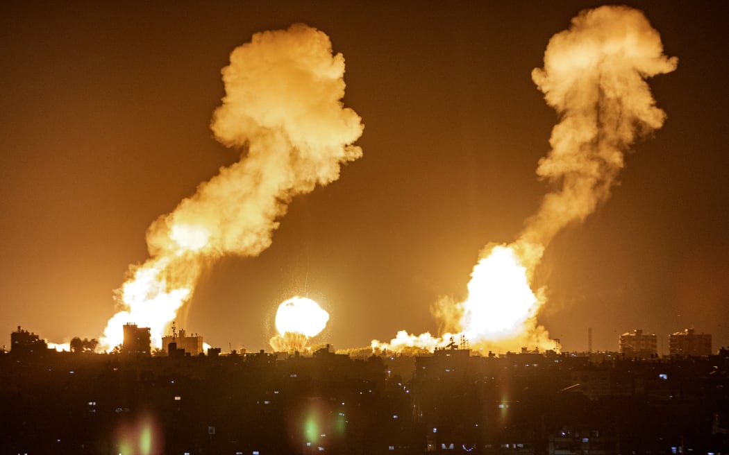 This picture taken early on April 7, 2023 shows explosions in Khan Yunis in the southern Gaza Strip during Israeli air strikes on the Palestinian enclave. (Photo by Yousef MASOUD / AFP)