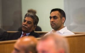 Gurjinder Singh (right) sitting in the dock at Auckland High Court with a translator (left).