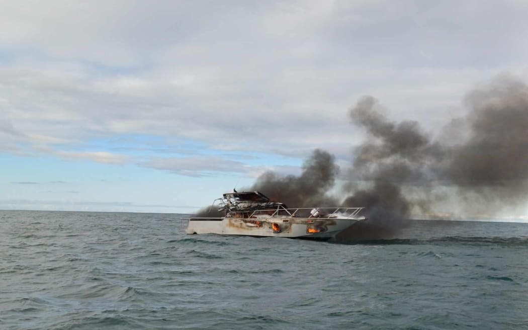 The ship ablaze in Mercury Bay.