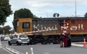 A car was struck but a freight train seconds after those in it had escaped.