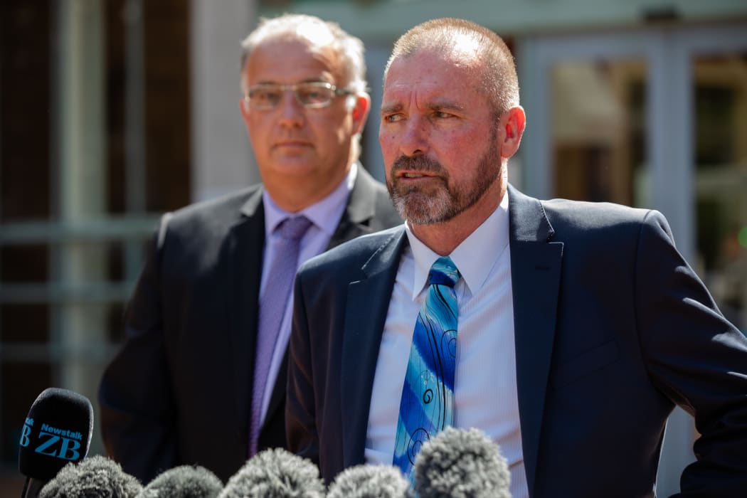 Detective Inspector Scott Beard, right, speaks to media outside the High Court at Auckland following the sentencing of Grace Millane's murderer, 21 February 2020.